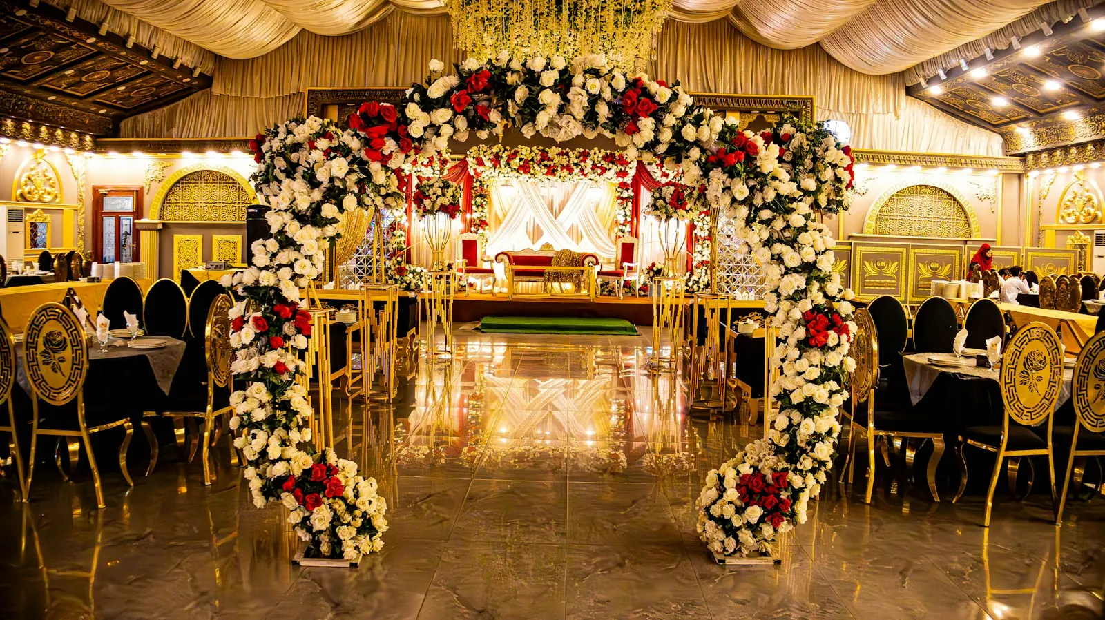 Floral arch décor at an indoor celebration venue